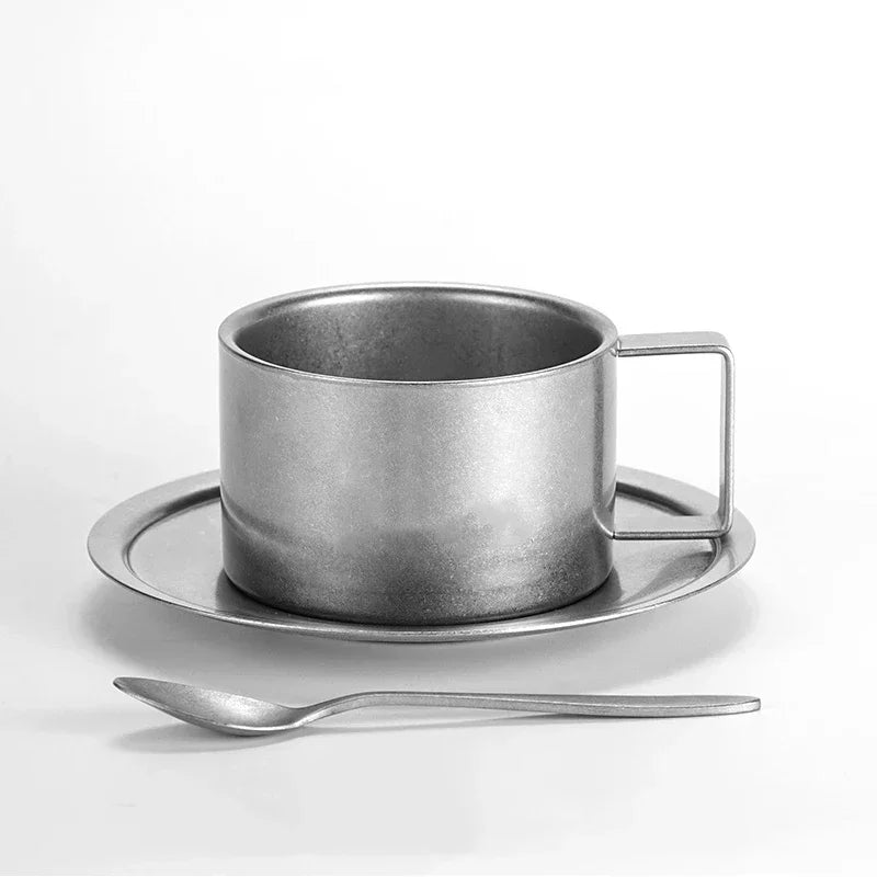 Taza de café de acero inoxidable con platillo y cuchara a juego